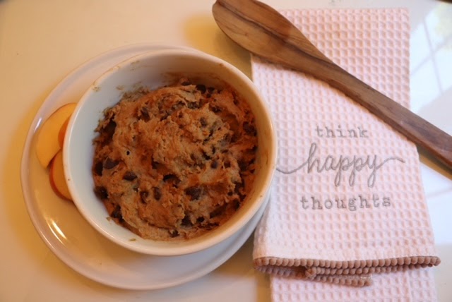 cookie dough on table with wooden spoon and tea towel